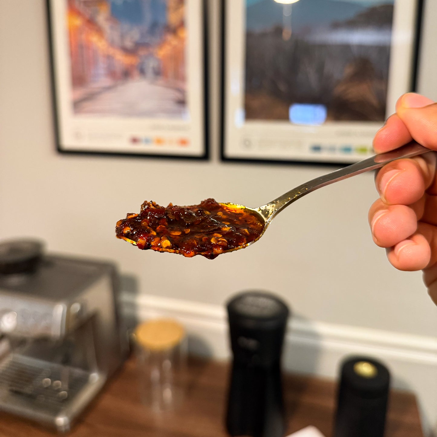 Spoonful of El Pueblo chili oil showing rich chili flakes and infused avocado oil